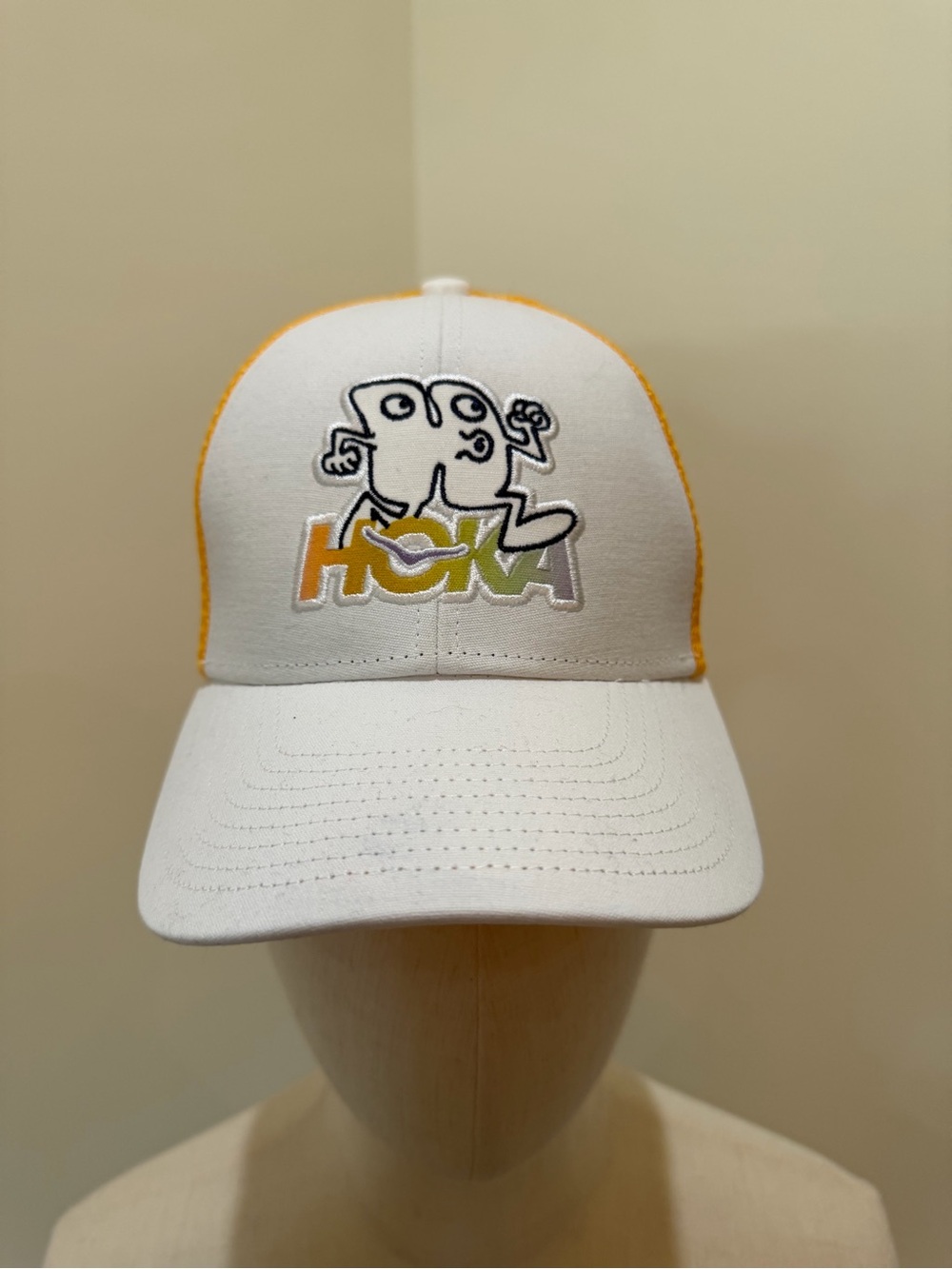 Hoka White Cap with Yellow Trim and Multicolor Logo